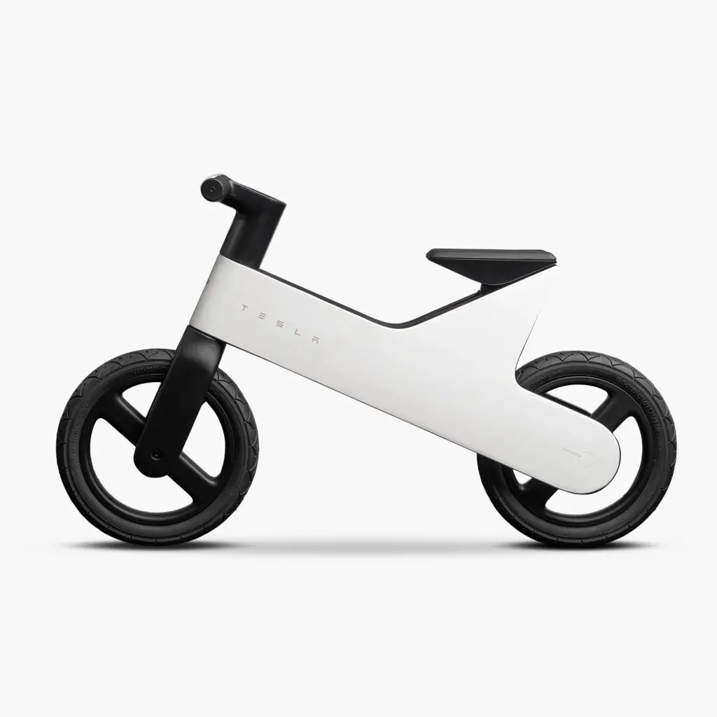 Side view of the Tesla Balance Bike, without pedals or motor, with the Tesla wordmark on the frame