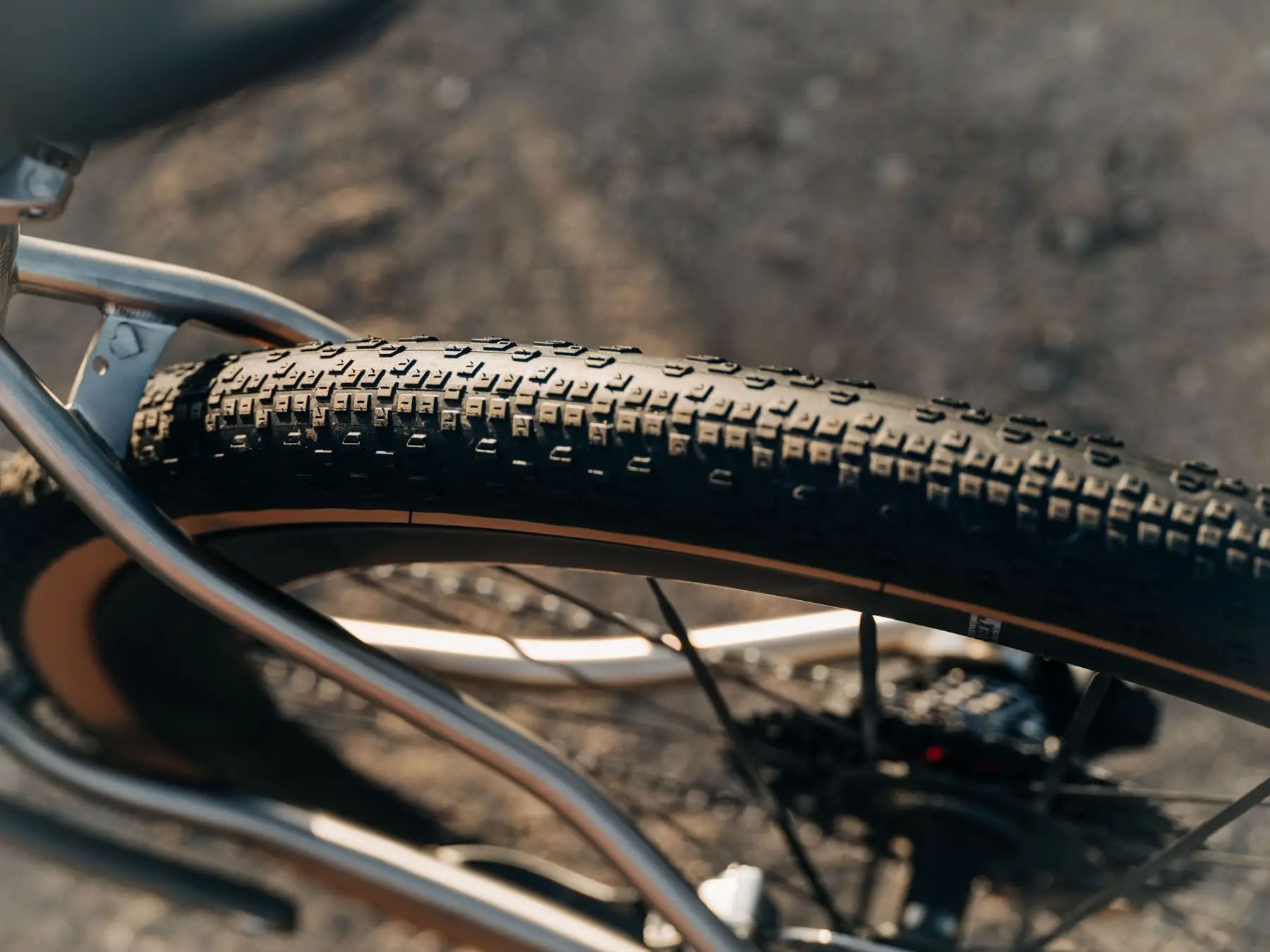 Gros plan sur le pneu gravel Cadex GXR monté sur une roue, avec sa bande de roulement crantée