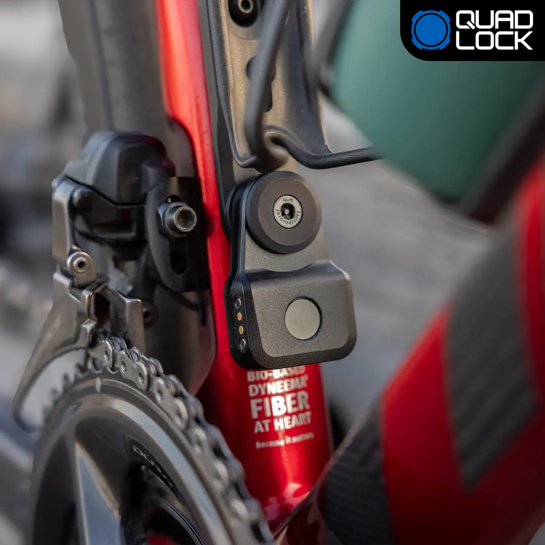 Quad Lock Bike Alarm and Finder unit mounted on a bottle cage