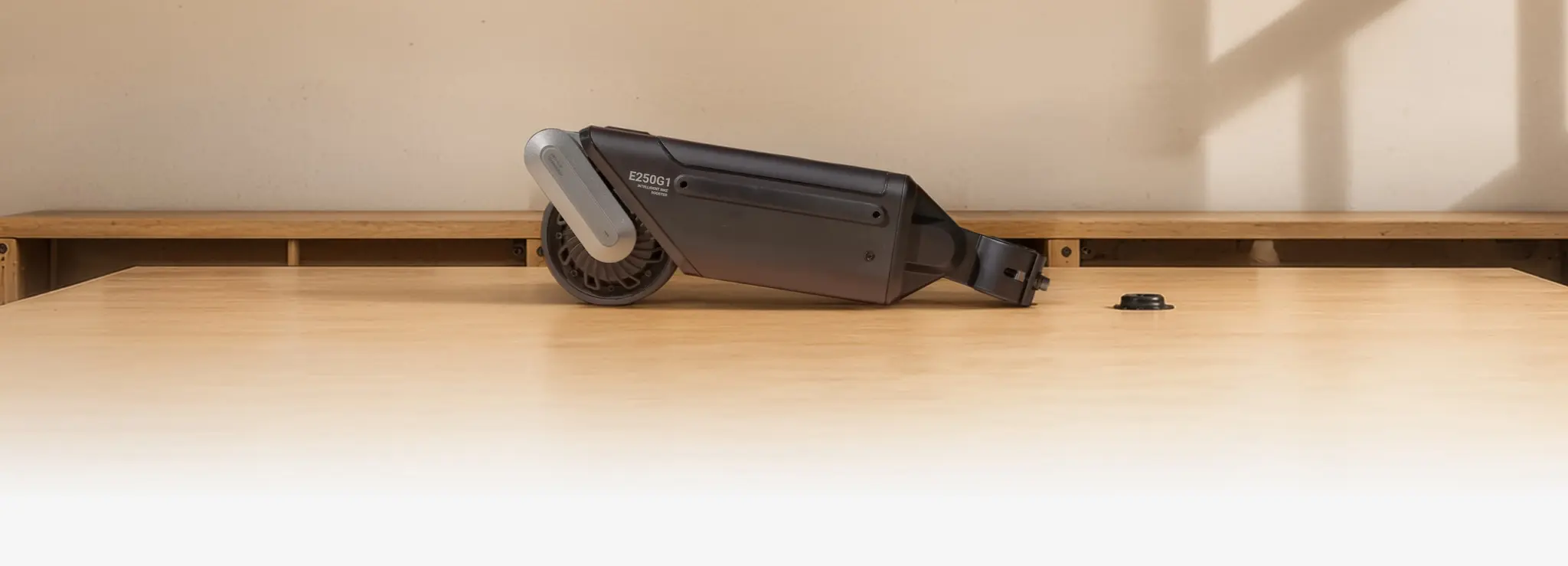 The ASUS Oxiis kit laid on a table, its drive roller visible at the front of the unit