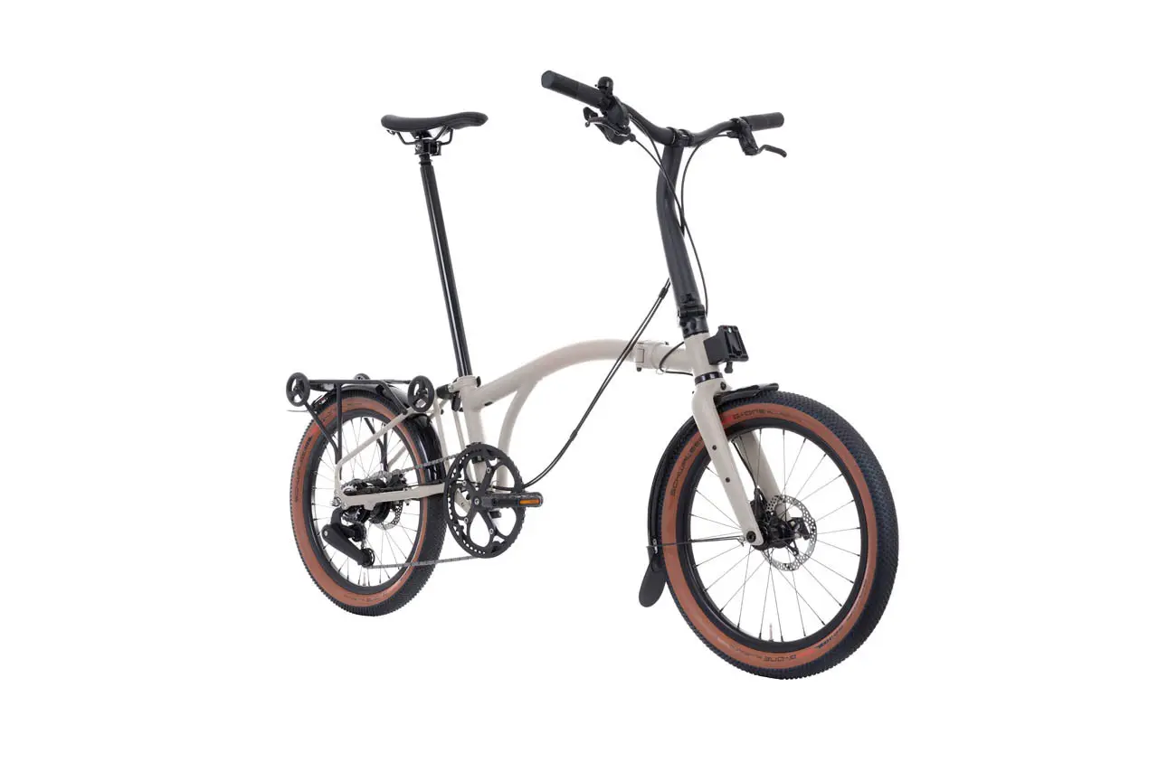 Stock Brompton G Line, light beige frame and knobbly tyres with brown sidewalls, three-quarter view on a white background
