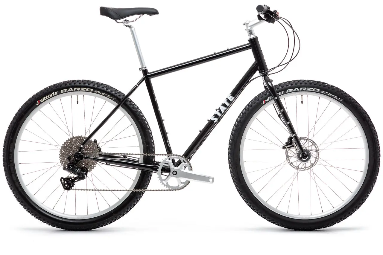 Black State Bicycle 4130 All-Road Flat Bar in profile, with flat bar, knobby Vittoria Barzo tyres and disc brakes