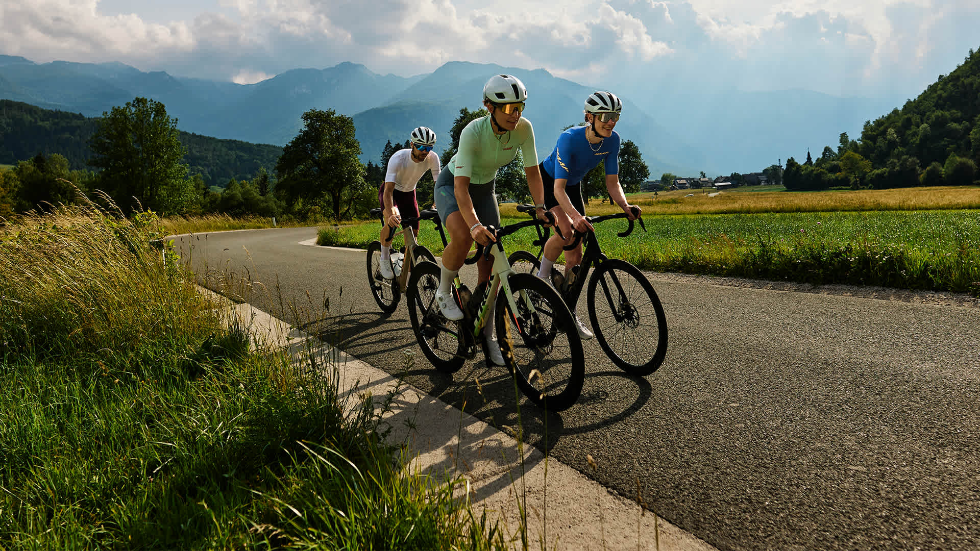 Three cyclists riding the Trek Domane+ SL on a mountain road