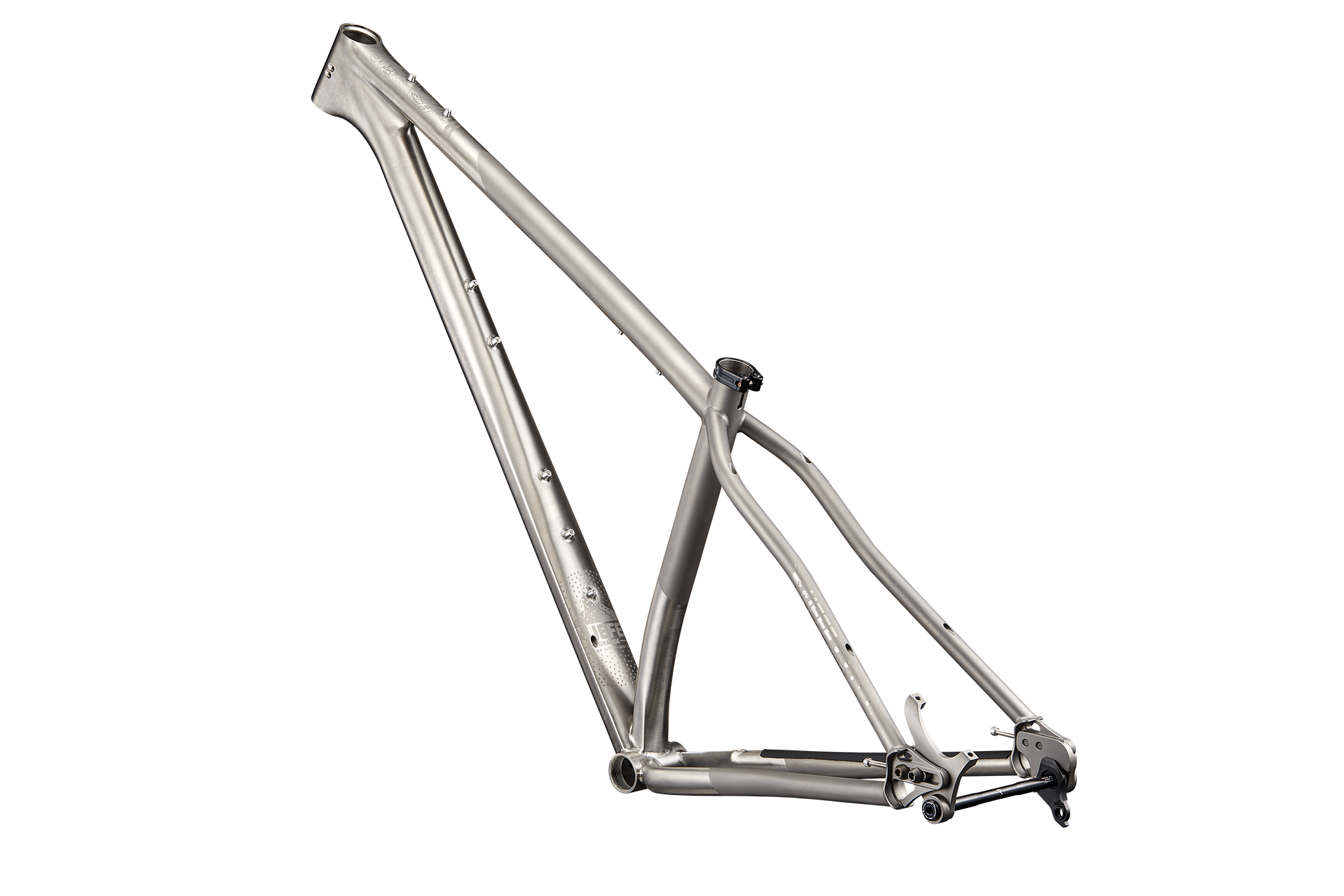 The bare Revel El Jefe Grande frame in brushed titanium, seen from the rear three-quarter