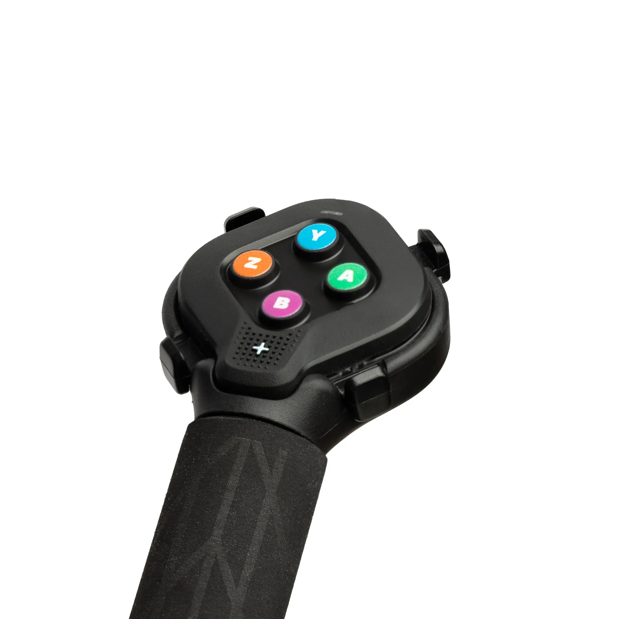 Manette Zwift Click à quatre boutons colorés fixée au bout d'une extension