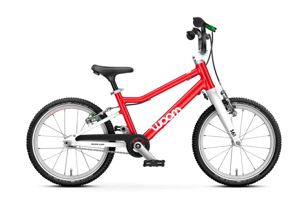 The red woom GO 3 kids' bike, side view